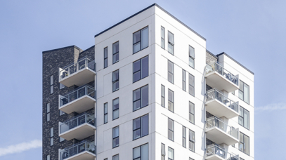 A vertical shot of a white building under the clear sky